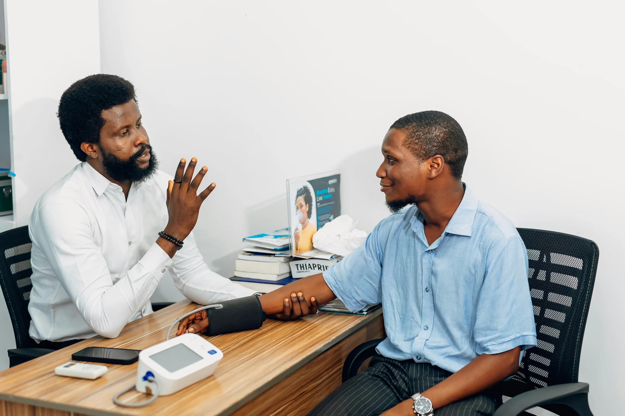 A doctor checking a patient's blood pressure during a consultation